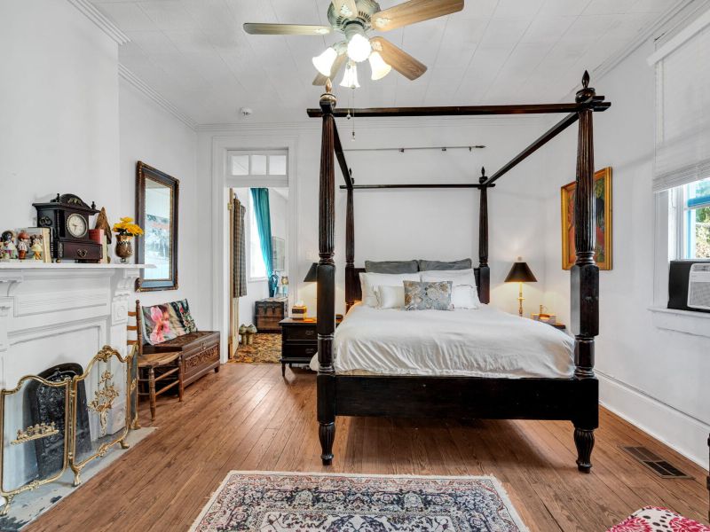 Spacious four-poster king bedroom w/ an airy, serene feel.