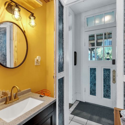 Bold, sunny bathroom w/ vibrant NOLA color & character.