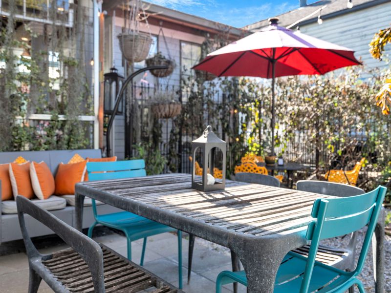 Private courtyard table set for an alfresco meal w/ good company.