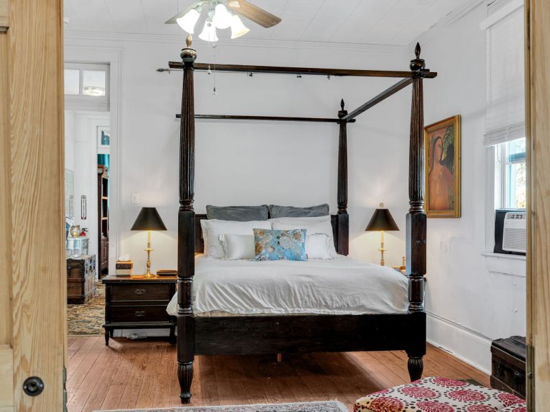 Spacious four-poster primary bedroom w/ elegant details throughout.