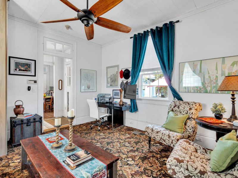 Sunlit living space w/ local flair & vibrant character.