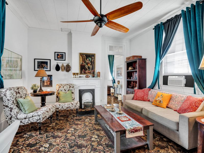 Warm living room w/ eclectic charm flowing into the outdoor space.
