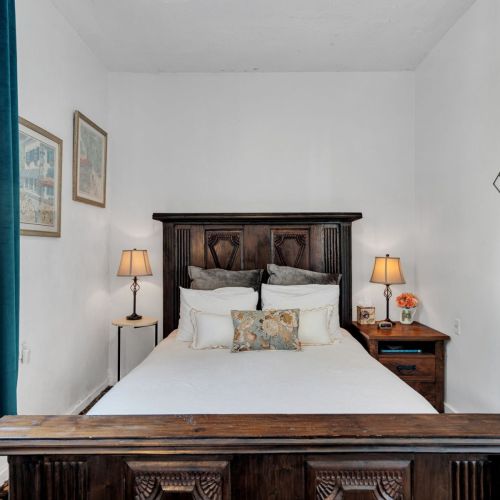 Warm guest bedroom w/ timeless style & inviting comfort.