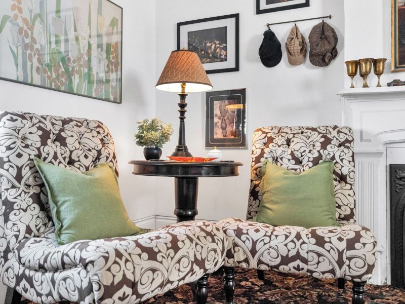 Intimate seating nook w/ lush greenery for quiet moments.
