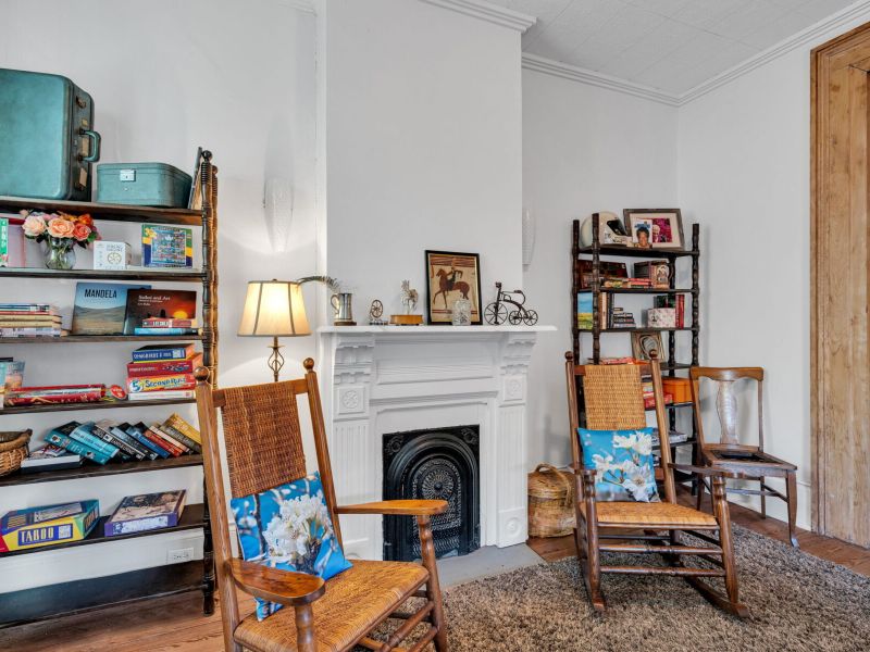 Cozy reading nook anchored by a classic fireplace.