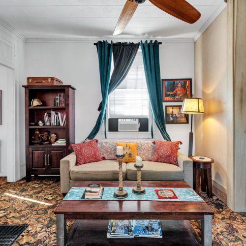 Bright, cozy living room full of classic NOLA charm.