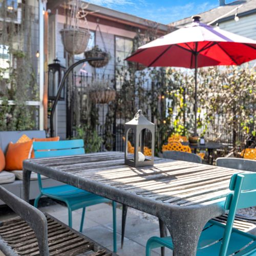 Private courtyard table set for an alfresco meal w/ good company.