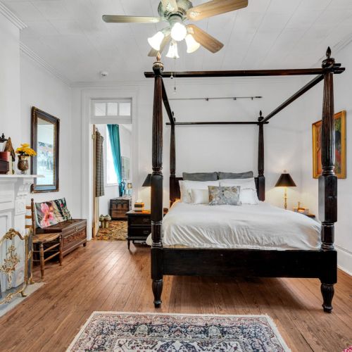 Spacious four-poster king bedroom w/ an airy, serene feel.