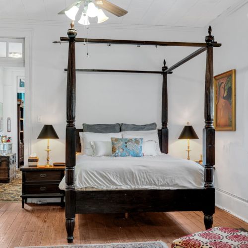 Spacious four-poster primary bedroom w/ elegant details throughout.