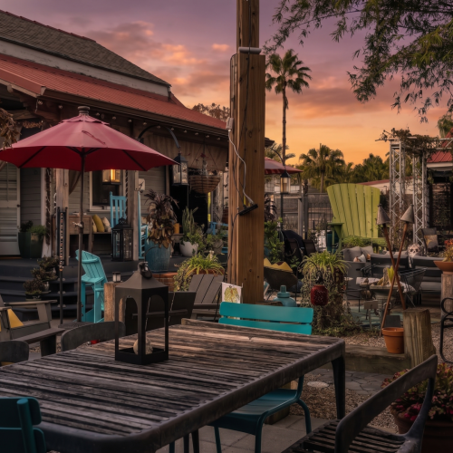 Sunny patio shaded by an umbrella — ideal for morning coffee or evening cocktails.