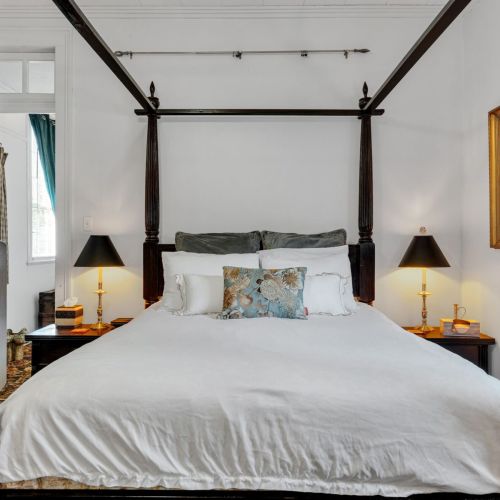 Dreamy four-poster king bed dressed for deep, restful nights.